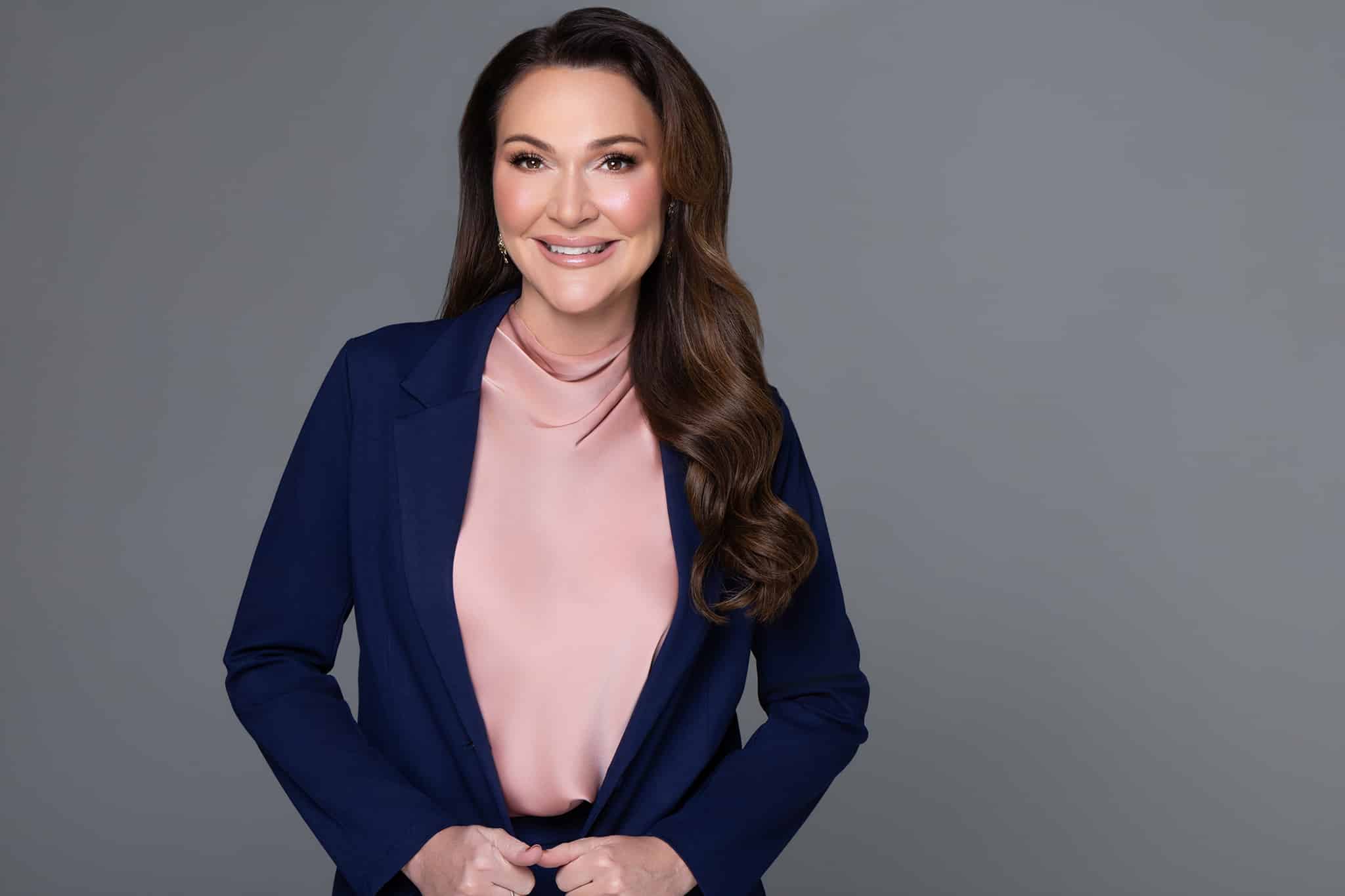 Bridget wearing pin shirt with suit