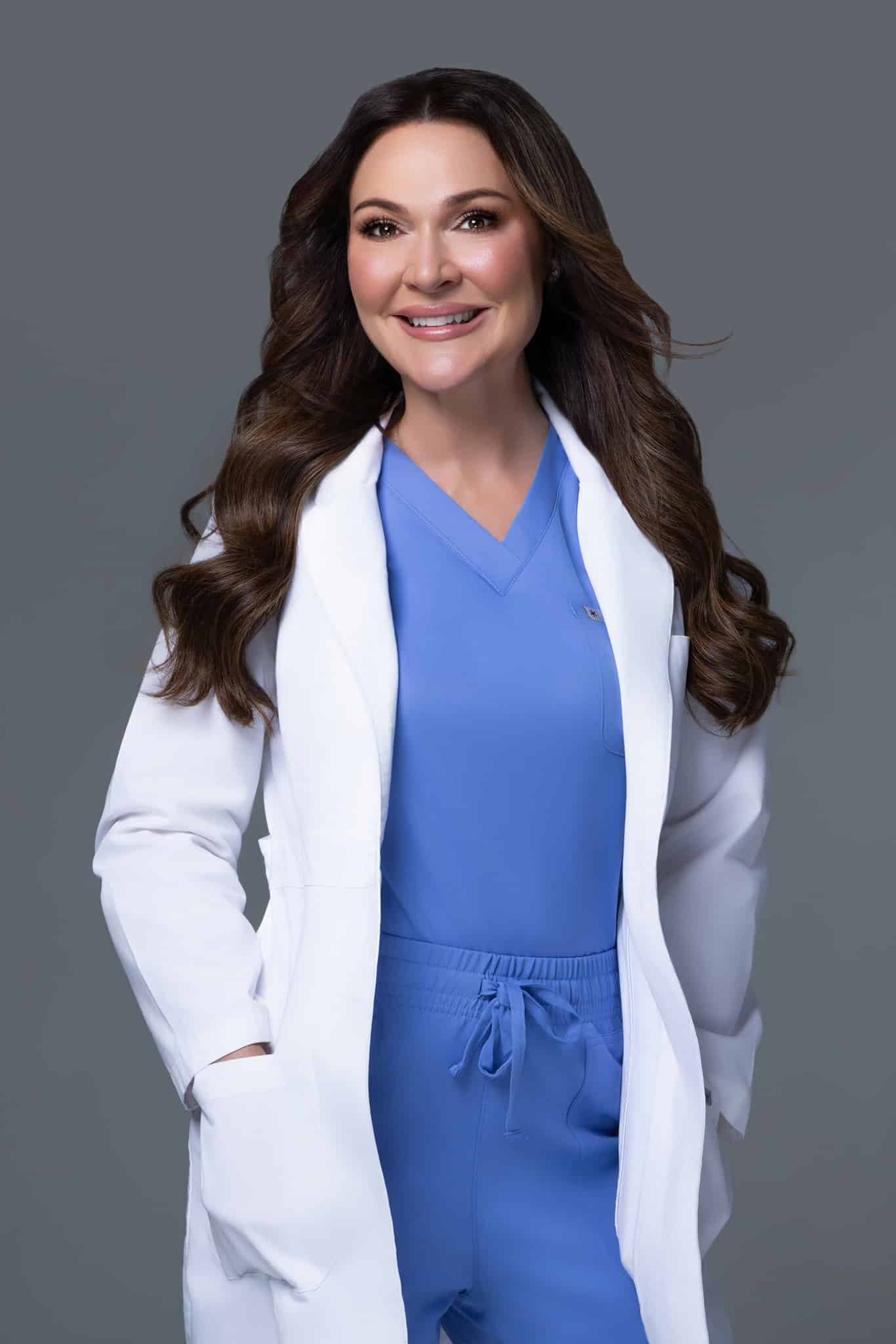 Smiling doctor Bridget Fitzgibbons in blue scrubs